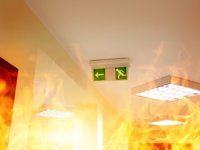 A fire disaster in a building with an exit sign