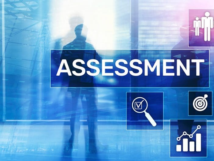 IT assessment typed in a box on a blurred blue background