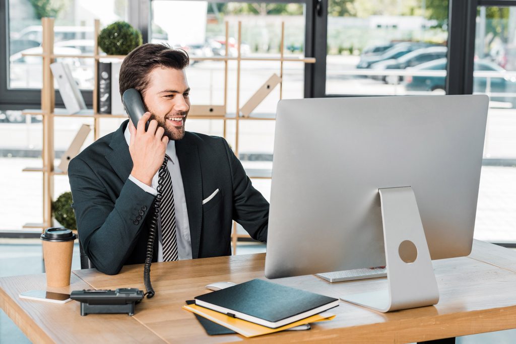 Businessman with computer contacting IT support remotely from home office
